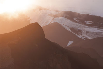 Scenic view of mountains against sky during sunset