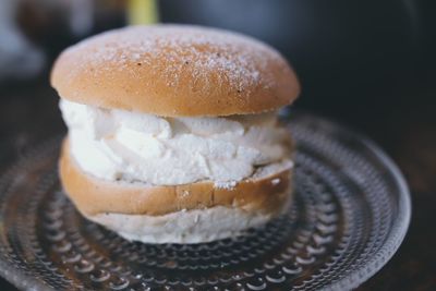Close-up of a bun with whipped cream called selma  on table