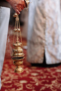 Midsection of woman holding wedding dress