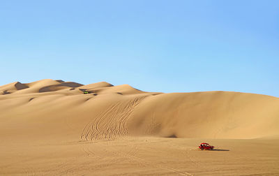 Dune buggies running on the amazing huacachina sand dunes in ica region, peru, south america