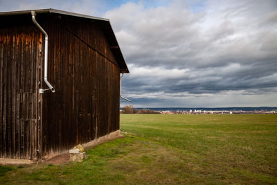 Built structure on field against sky