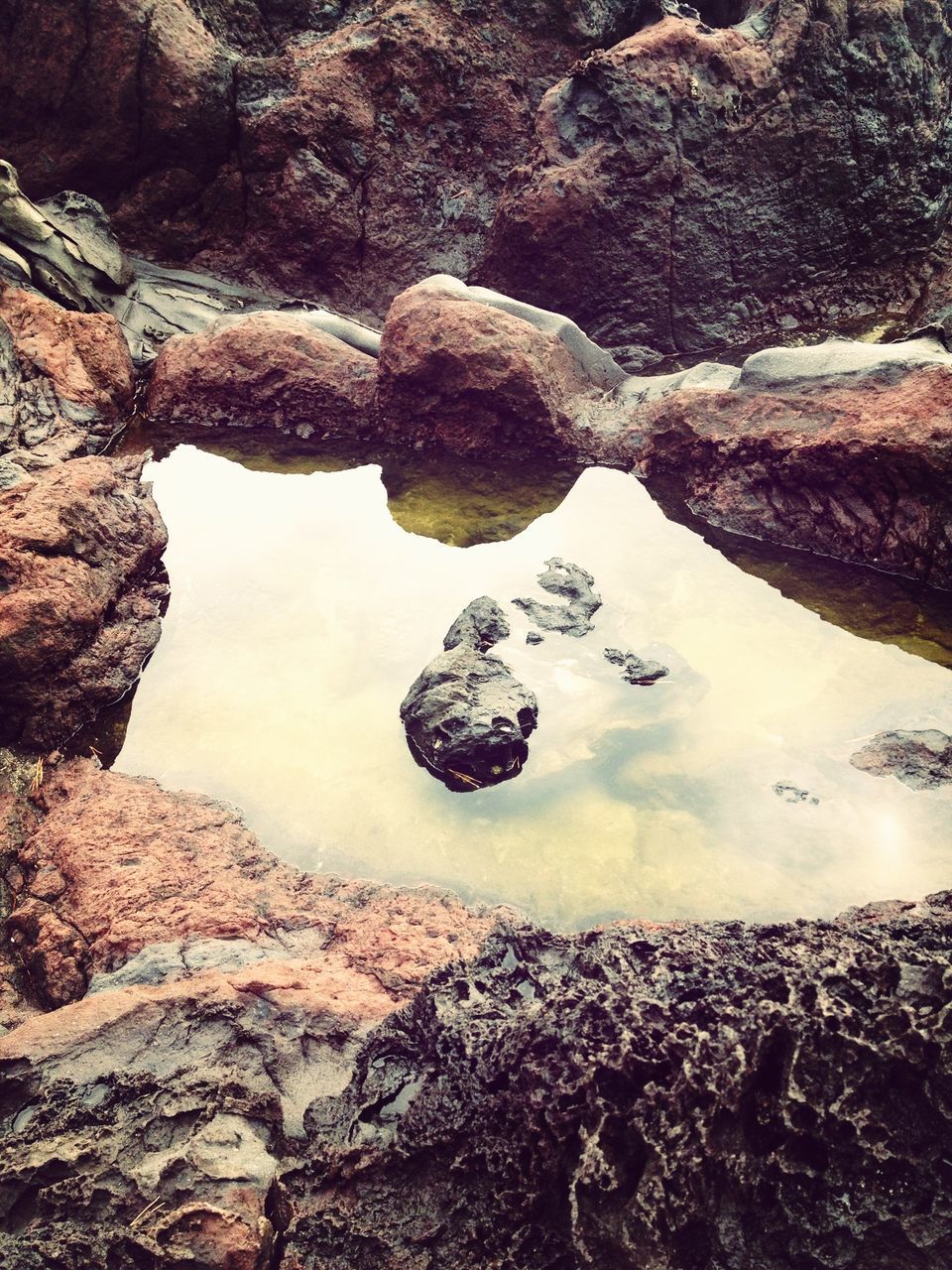 water, rock - object, tranquility, nature, reflection, high angle view, beauty in nature, tranquil scene, beach, scenics, lake, stone - object, day, shore, rock formation, river, outdoors, rock, no people, standing water