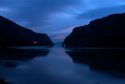 Scenic view of lake against sky at dusk