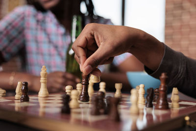 Cropped hand playing chess