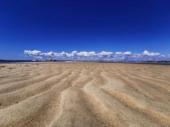 Scenic view of landscape against blue sky