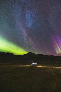 Scenic view of landscape against sky at night