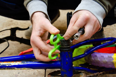 Low section of man repairing bicycle