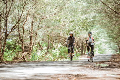 Rear view of man riding bicycle