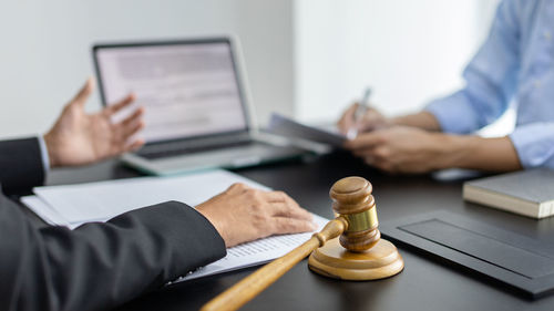 Midsection of businessman working on table