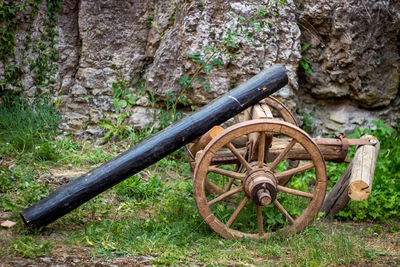 Close-up of abandoned wheel against trees