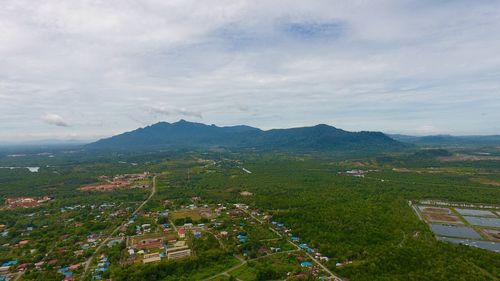 Scenic view of agricultural landscape against sky