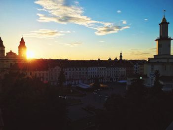 View of buildings in city at sunset