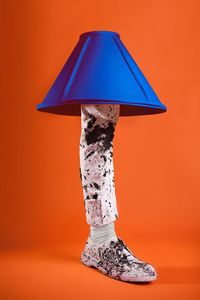 Artificial dirty leg with lamp over orange background