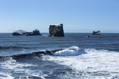 Basalt stones in the ocean, vik, iceland in wintertime