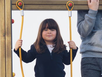 Portrait of girl holding play equipment