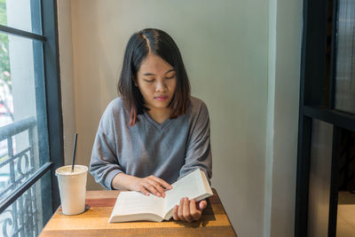 Portrait of young woman sitting at home