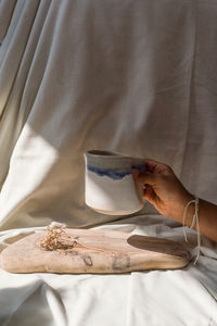 Hand holding ceramic cup