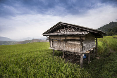 Built structure on field against sky