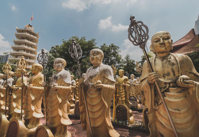 Statue against temple against sky