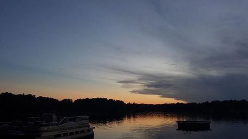 Boats in lake at sunset