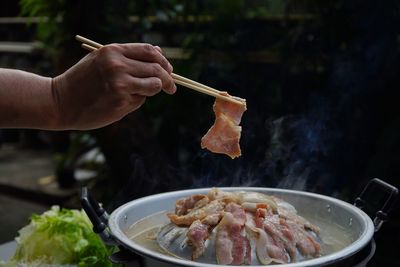 Thailand style bbq grill on a charcoal fire that is located on the bottom with pork, shrimp, squid 