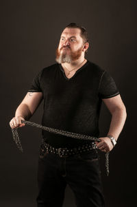 Man wearing mask against black background