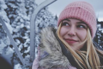 Close-up portrait of smiling young woman during winter