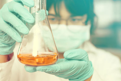 Scientist holding flask with chemical