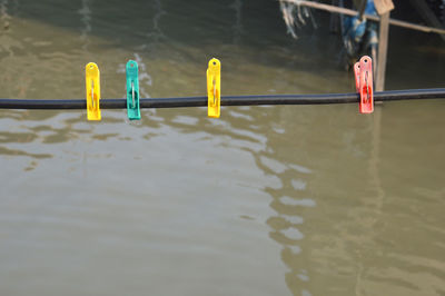 Deck chairs on railing by lake