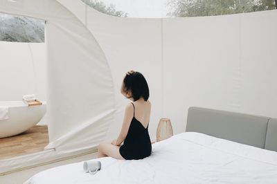 Woman sitting on table at home