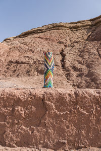 Multi colored umbrella on rock