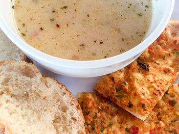 High angle view of soup with bread served in plate