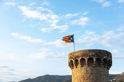 Low angle view of flag against sky