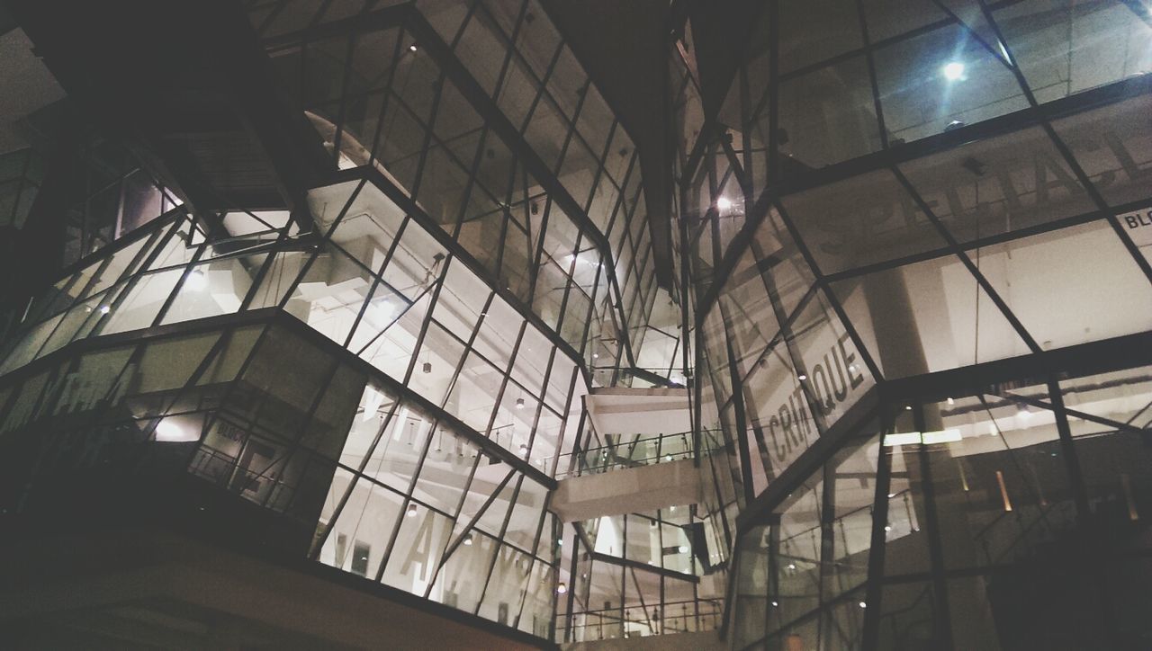 indoors, architecture, built structure, ceiling, low angle view, illuminated, window, interior, building, modern, lighting equipment, glass - material, building exterior, night, no people, reflection, light - natural phenomenon, architectural feature, sunlight, skylight