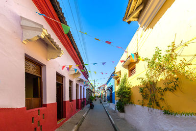 Street amidst buildings against sky in city