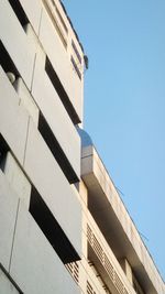 Low angle view of building against clear blue sky