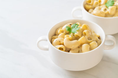 Close-up of pasta in bowl on white background