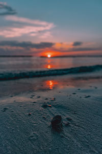 View of a beach with a sunrise in the background