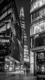 Low angle view of illuminated modern buildings and shard london bridge