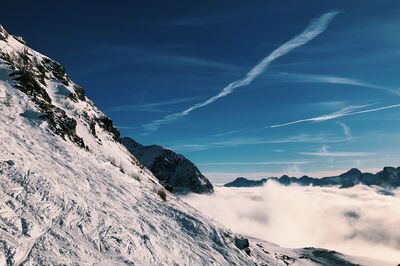 Scenic view of mountains against blue sky