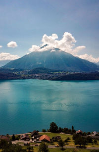 Scenic view of sea and mountains against sky