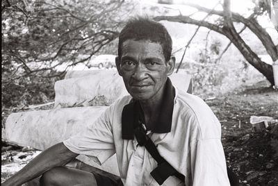 Portrait of smiling man sitting outdoors