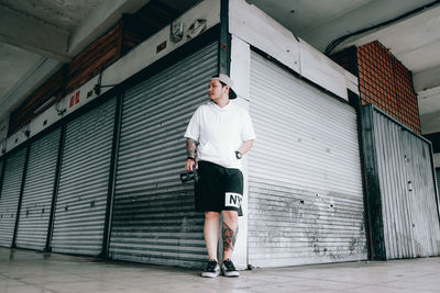 Full length of man walking against building