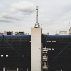 Modern tower against sky in city