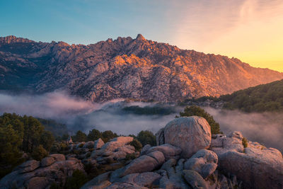 Scenic view of rock formation against sky during sunset