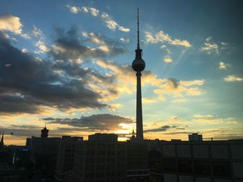 Communications tower against cloudy sky