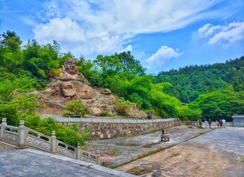 Trees in a temple against sky
