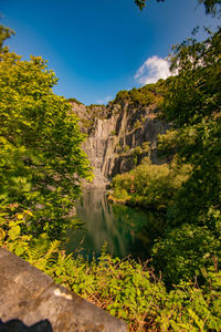 Scenic view of waterfall against sky