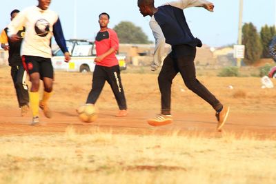 People playing soccer on field