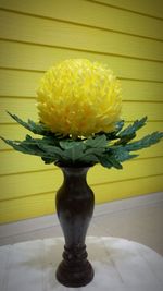 Close-up of yellow flower vase on table